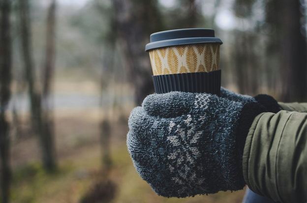 A warm cup and cozy winter moment that suggests slowing down and restoring energy.